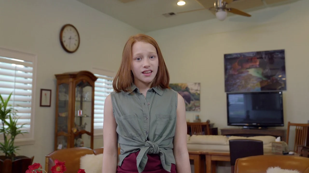 Opening scene of MC Plumbing’s “Handy Dad” commercial: a young narrator in a living room.
